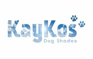 Logo of KayKos Dog Shades featuring the brand name in a blue cloud pattern. The name 'KayKos' is prominently displayed with a playful font, and the words 'Dog Shades' are located below. Two paw prints appear to the right.