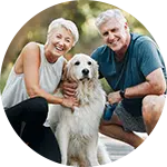 An elderly couple smiling while crouching beside their golden retriever in an outdoor setting. They appear happy and engaged, promoting the idea of animal rescue donations.