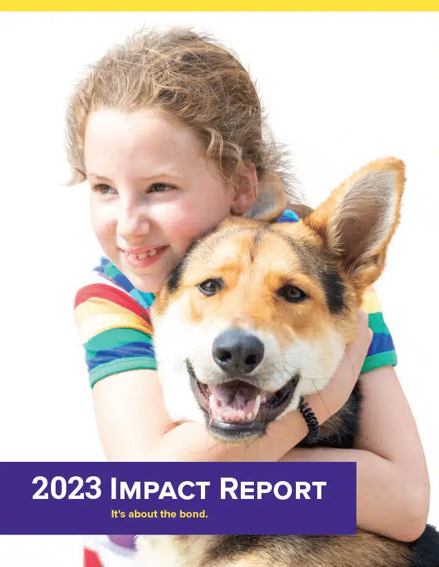 A girl with curly hair wearing a colorful striped shirt hugs a dog with a friendly expression. The image features the text '2023 Impact Report' at the bottom, emphasizing the bond between humans and animals.