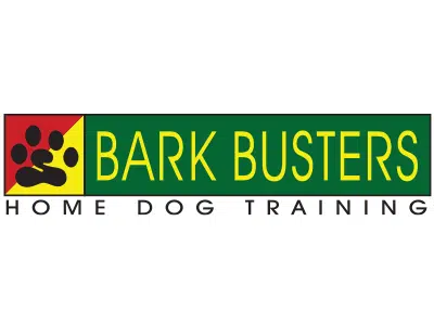Bark Busters Home Dog Training logo with a black paw print on red and yellow blocks beside green and yellow text on a white background.