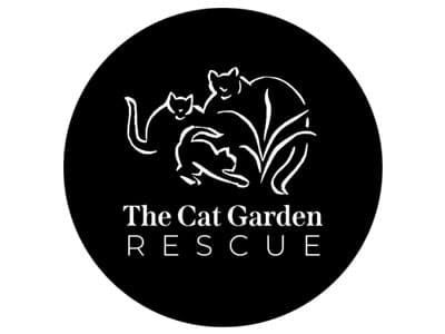 A logo for 'The Cat Garden Rescue', featuring three stylized cats amidst grass, all in white against a black circular background. The design emphasizes the organization's focus on cat rescue.