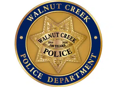 A Walnut Creek Police Department badge with a gold star emblem and blue circular border on a white background.
