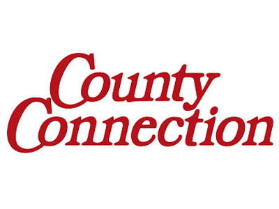 The logo of County Connection, displayed in bold red letters, with the word "County" on top of "Connection". The text is stylized with a cursive font for emphasis on the word "County".