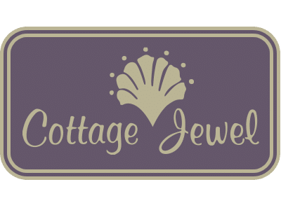 A logo titled "Cottage Jewel," featuring a stylized shell design above the text. The background is a deep purple, with the shell and text in a light beige color, enclosed within a rectangular border.