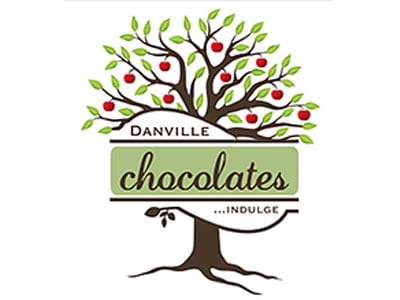 A logo featuring a stylized tree with green leaves and red apples, with the text "Danville chocolates... indulge" displayed prominently on a green banner across the trunk. The design is in a playful, modern style.
