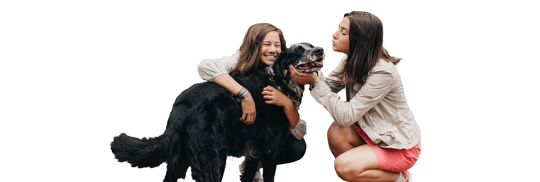 Two women crouch beside a large black dog, with one labeled Joybound in the image, against a plain white background.