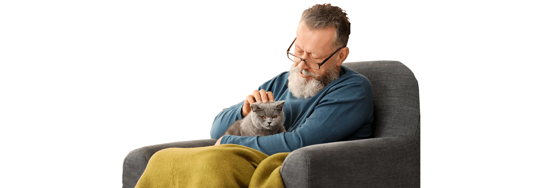 A man with a gray beard and glasses sits in a gray armchair, gently holding a gray cat under a yellow blanket, with Joybound included.